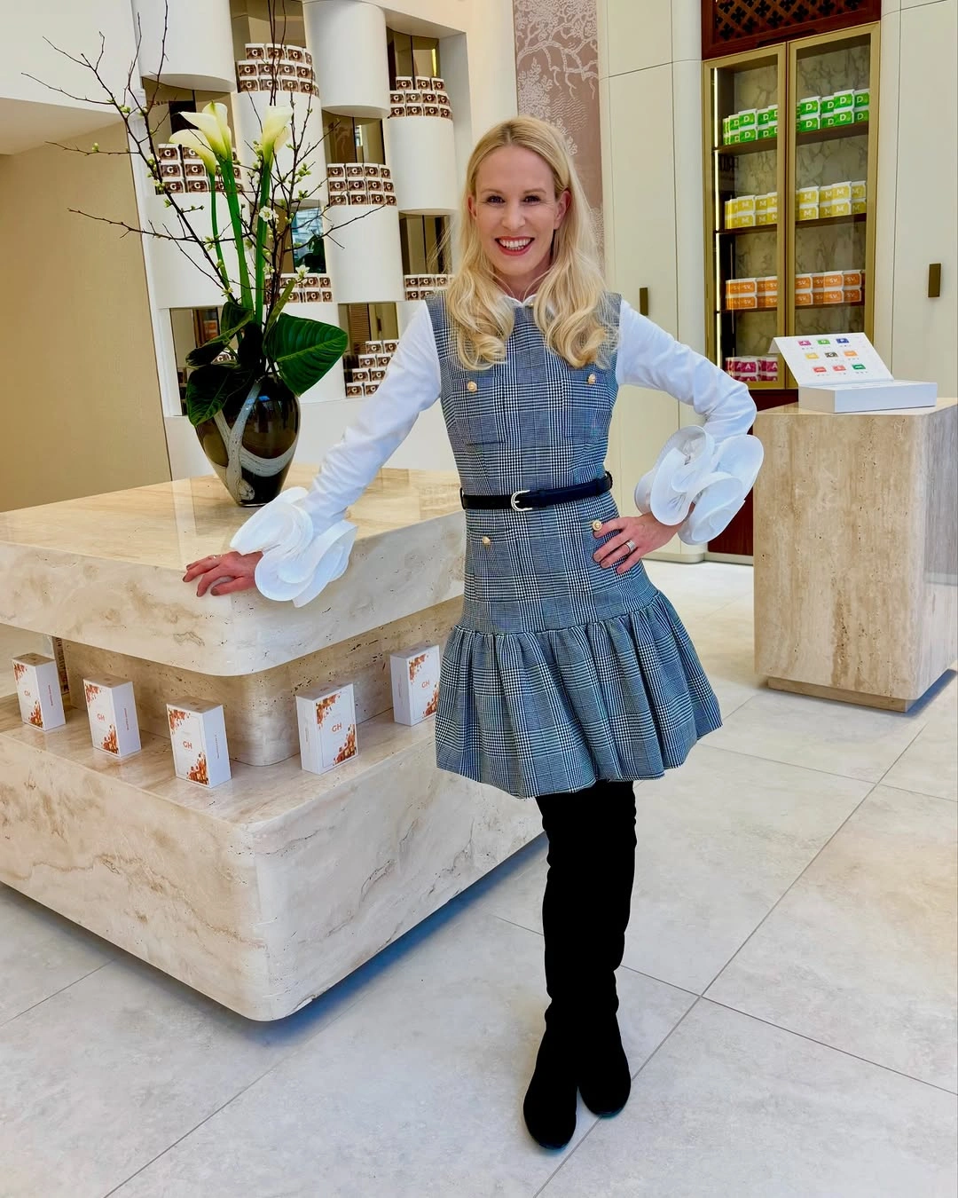 White ruffled blouse with gray plaid jumper shape and boots