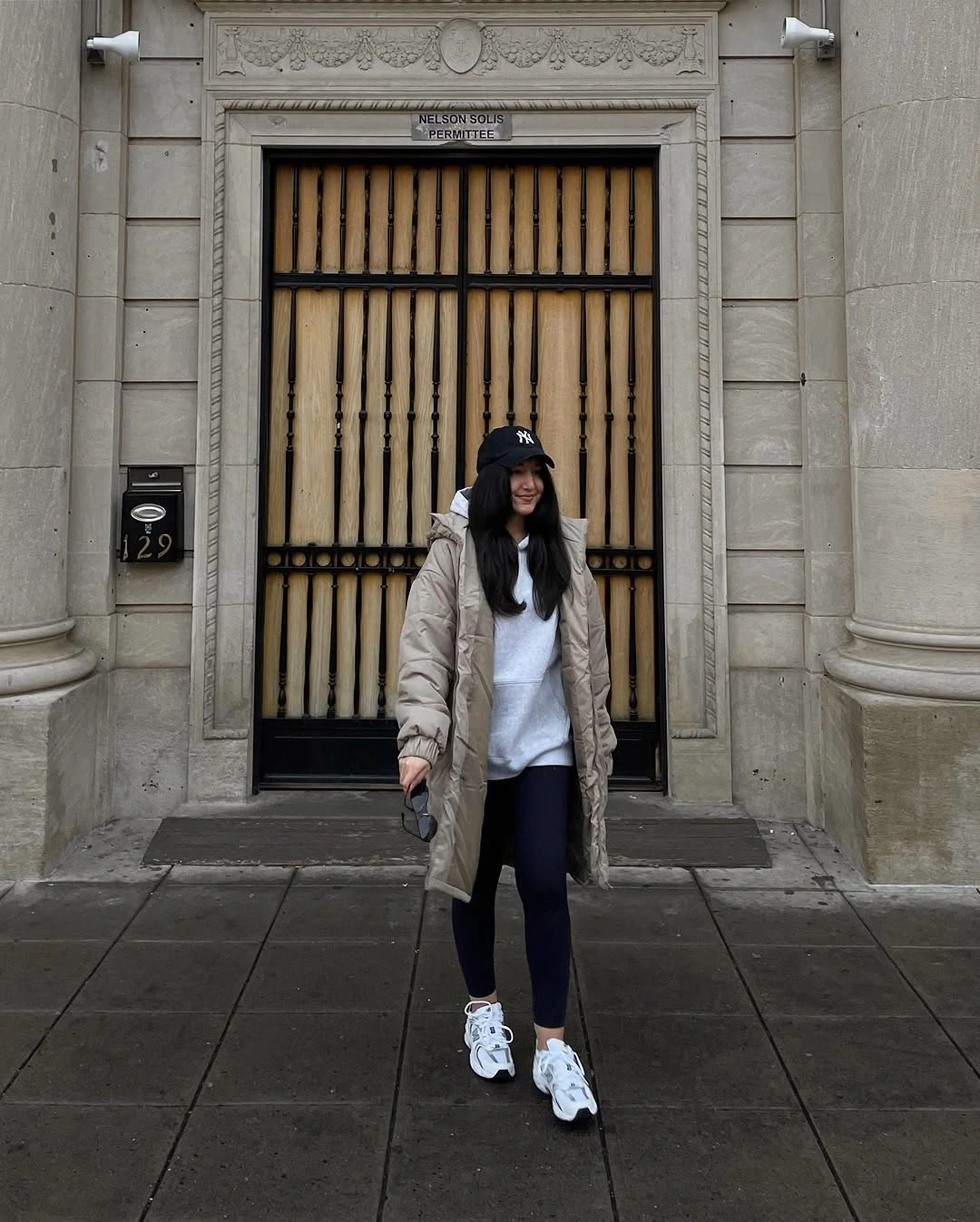 Light taupe puffer with white sweater and sneakers