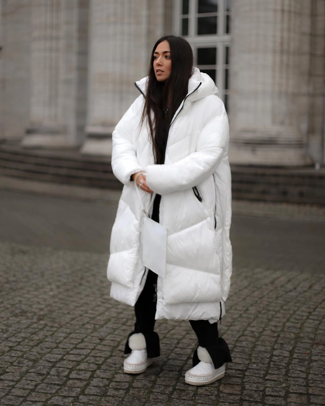 Long white puffer with black leggings and white winter shoes
