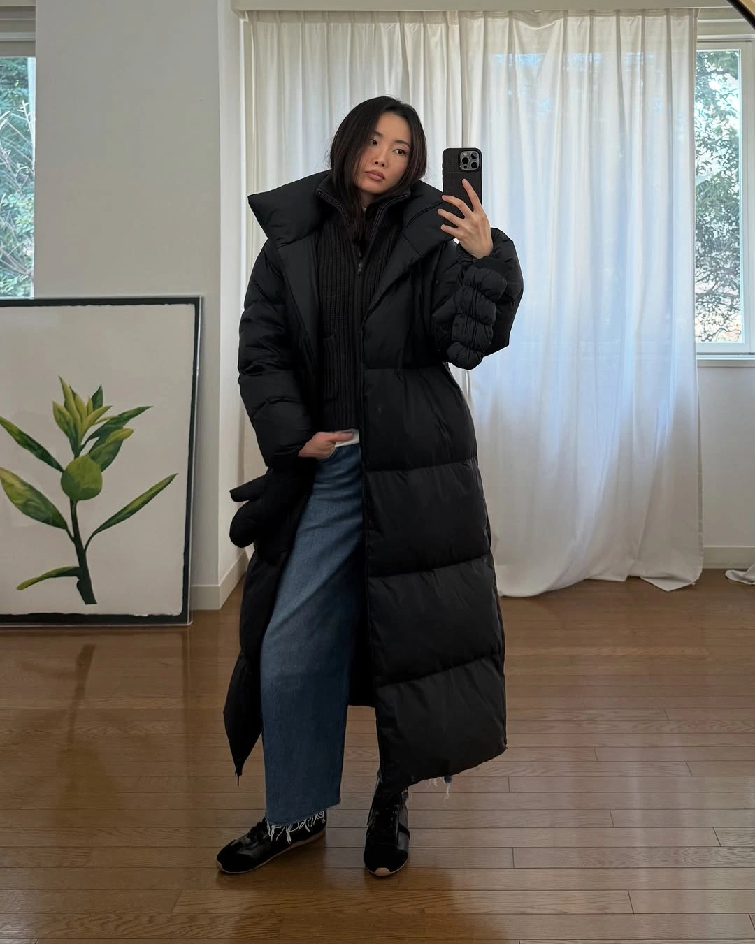 Long black puffer with stand collar wide jeans and boots