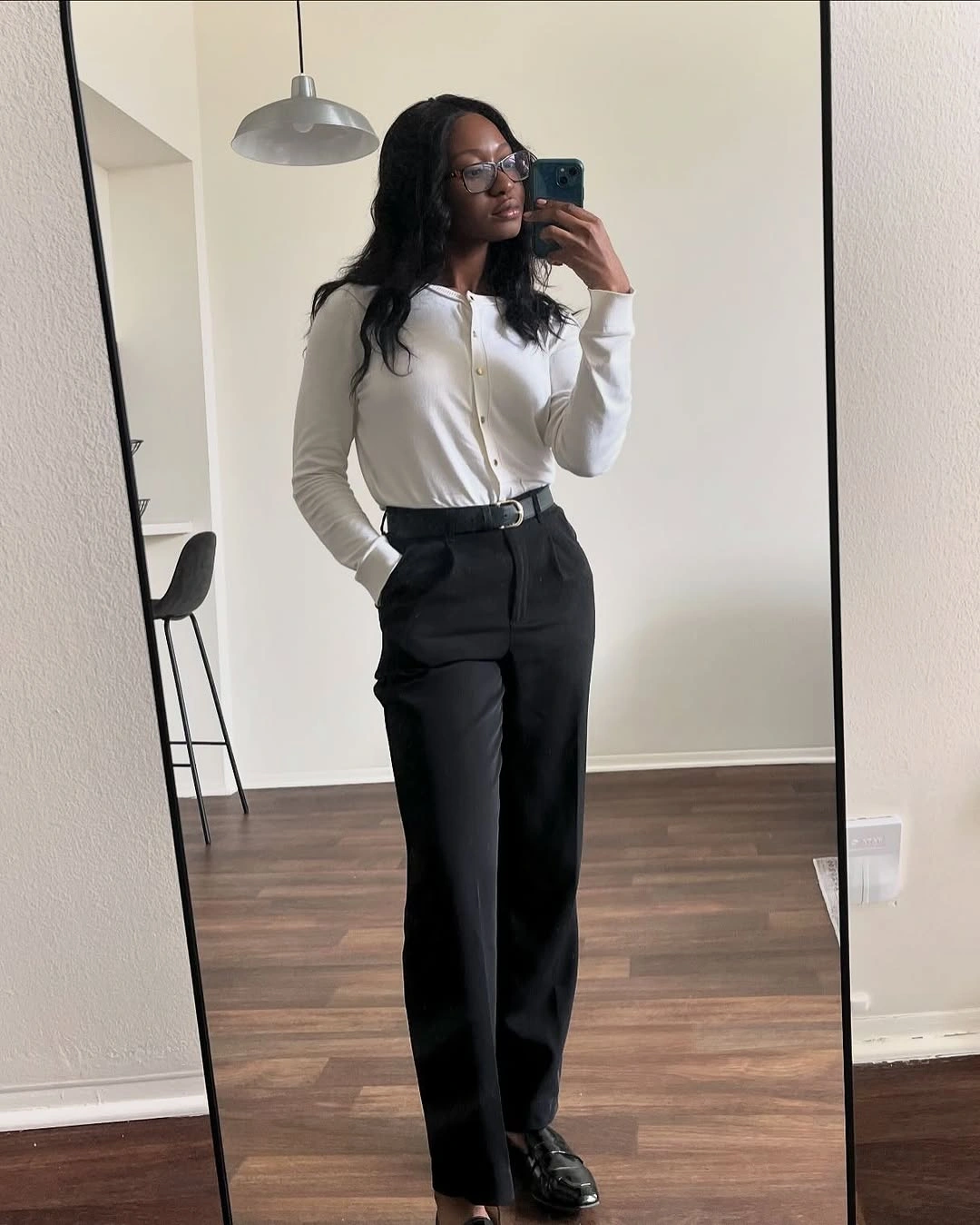 White cardigan black trousers and black belt outfit