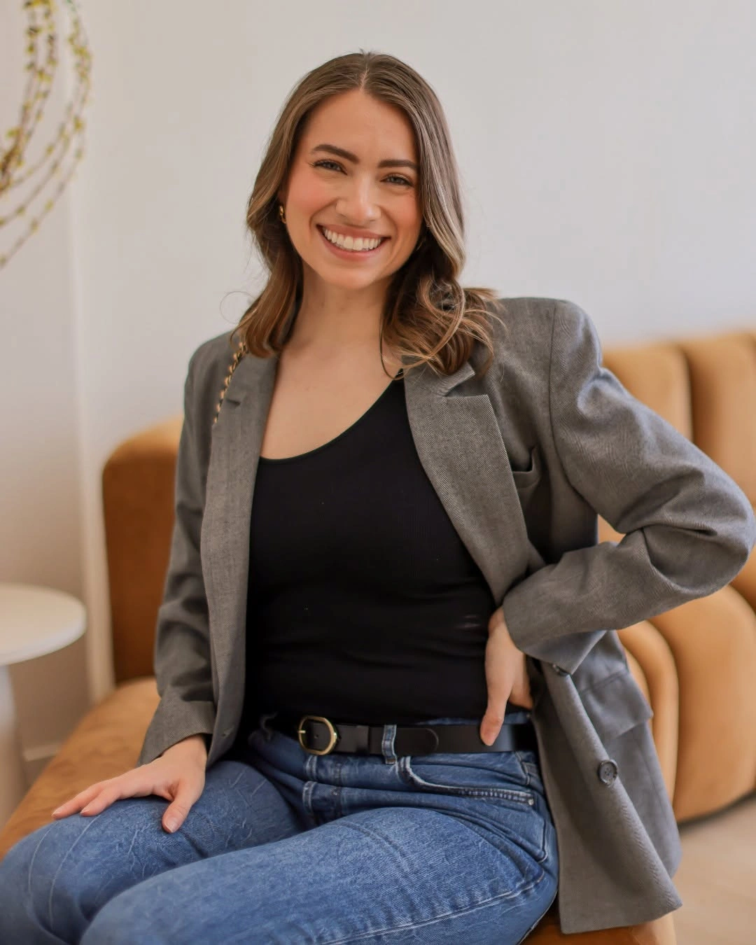 Gray blazer black top and blue jeans outfit