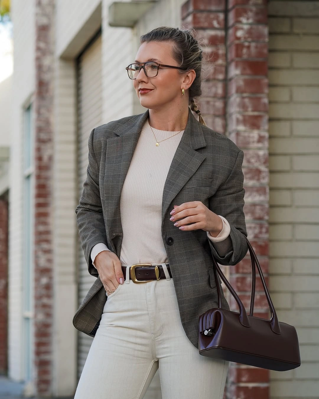 Gray plaid blazer light trousers and brown handbag