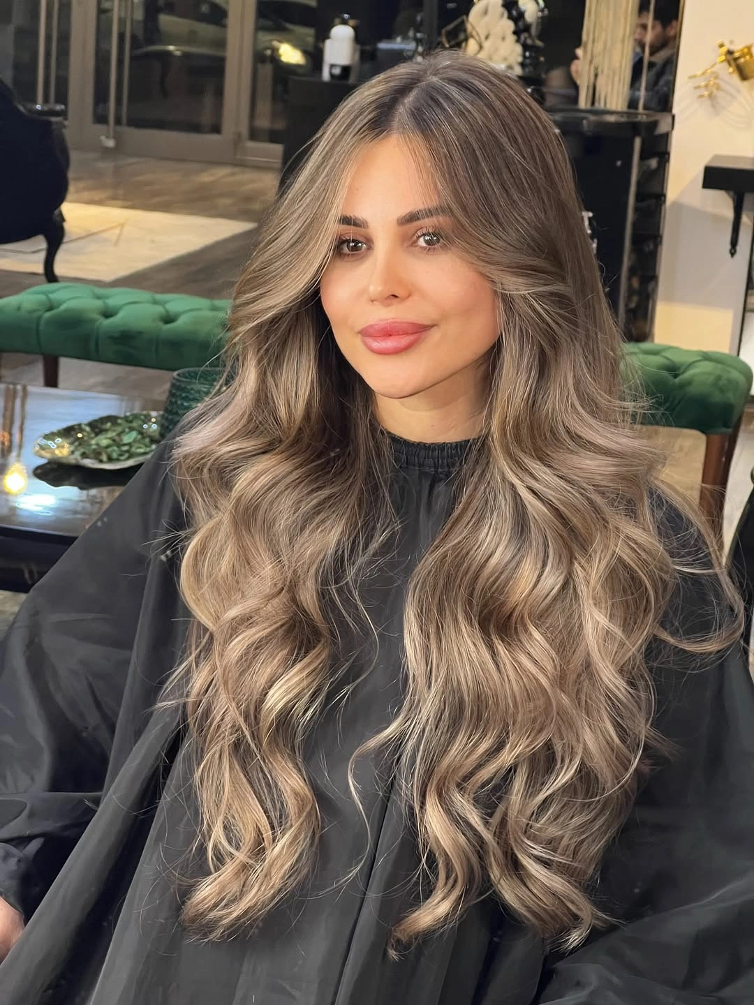 Long dark-rooted waves with sandy blonde ribbons