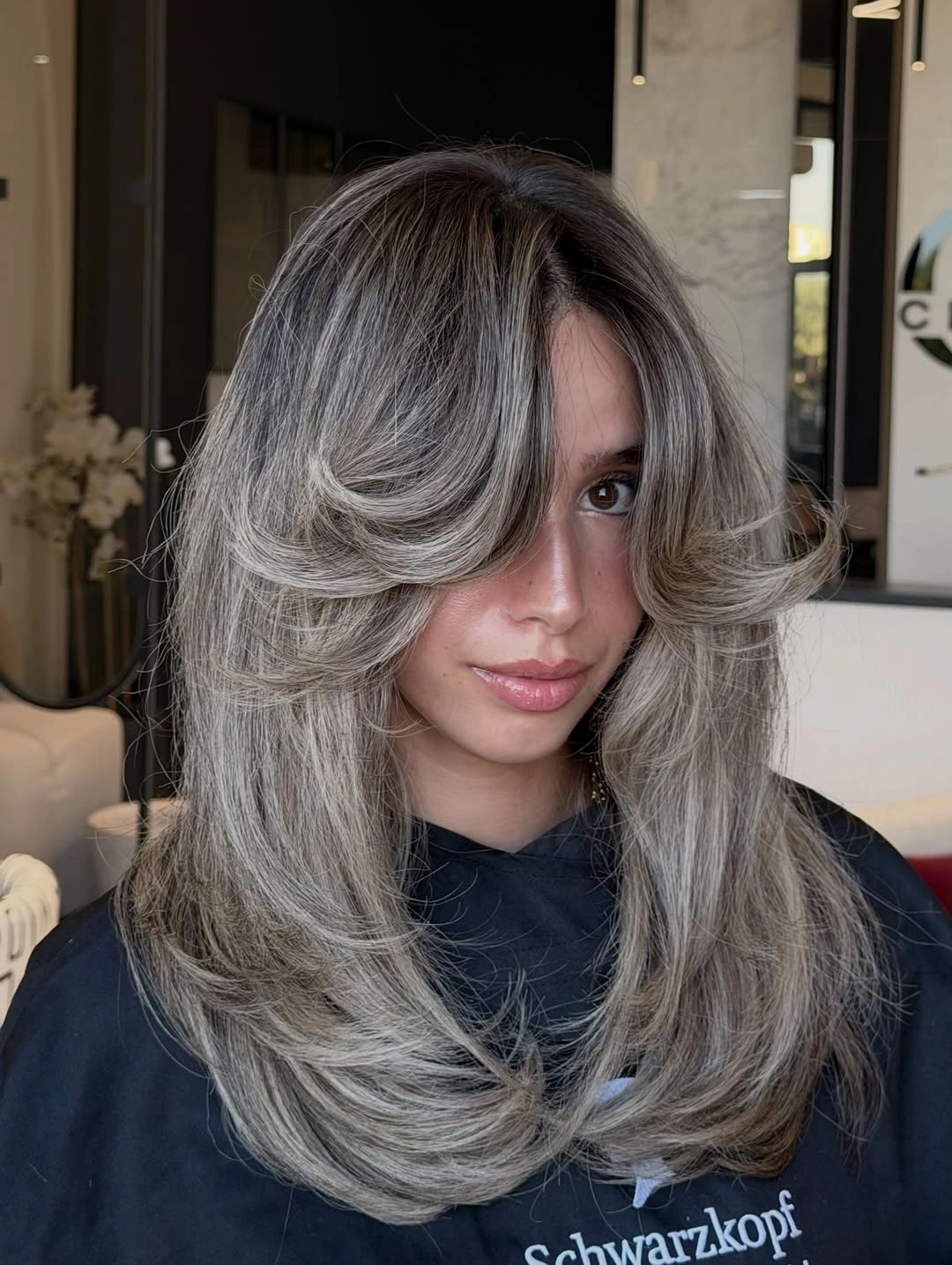 Layered ash beige waves with a broad side sweep