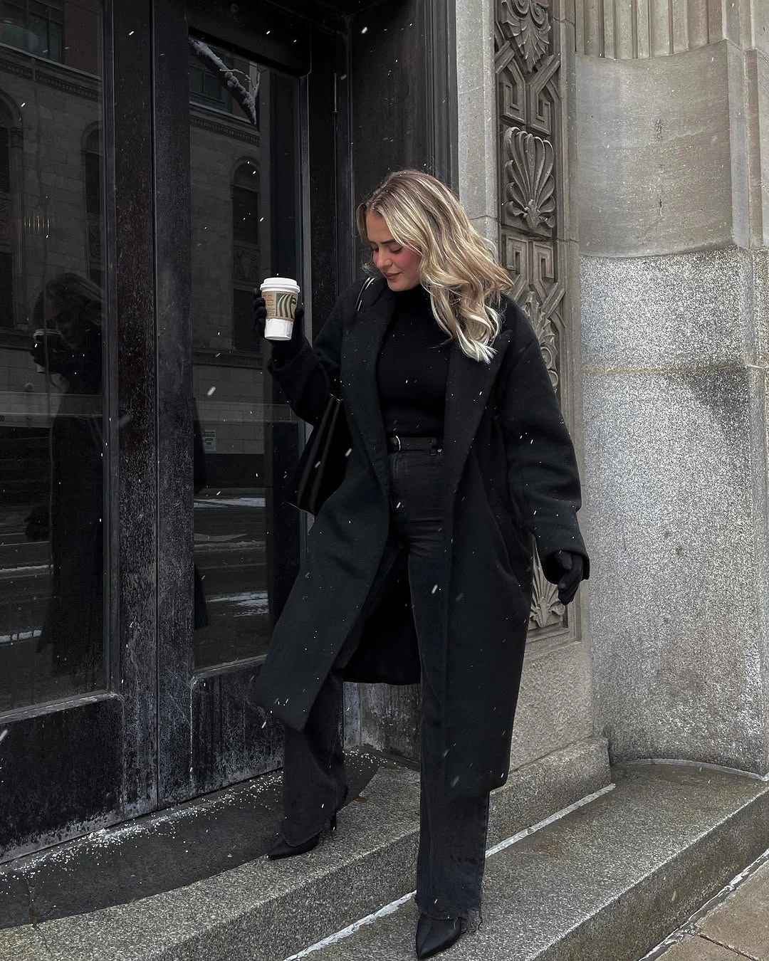 Black oversized coat with black jeans, gloves, and pointed ankle boots