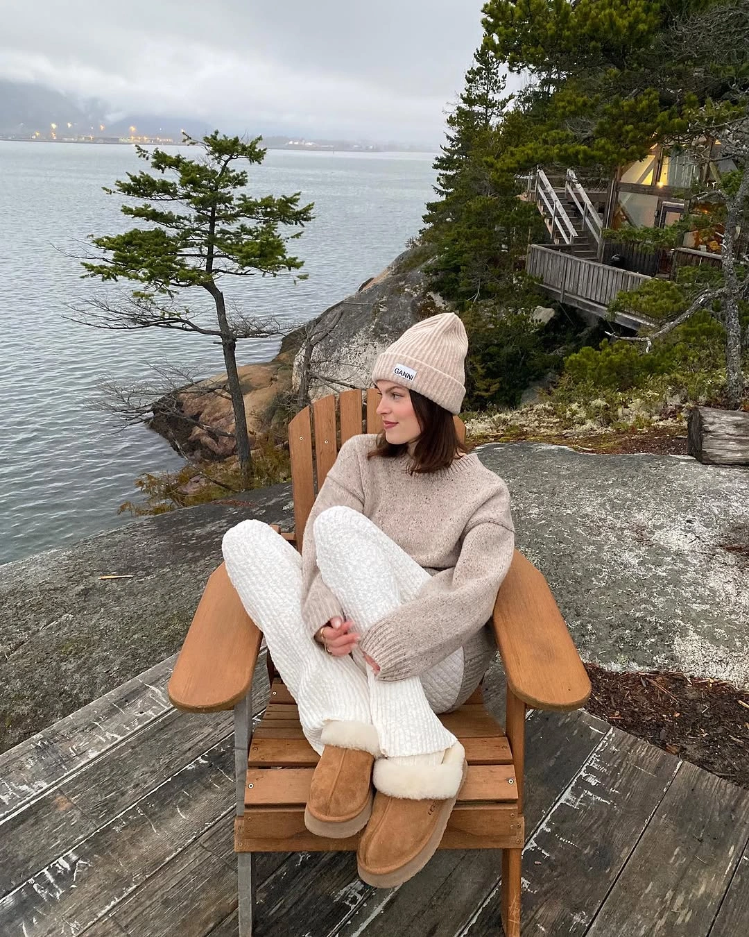 Taupe sweater with white textured trousers, pink beanie, and tan boots