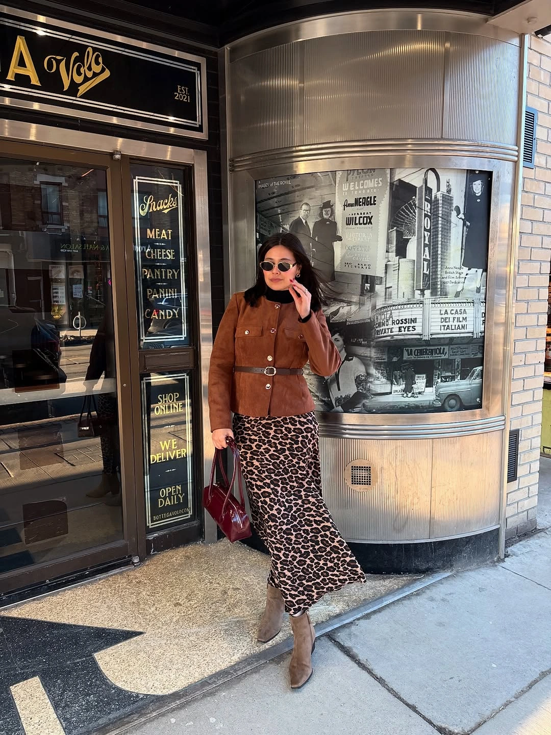 Brown fitted jacket with leopard-print long skirt and burgundy bag
