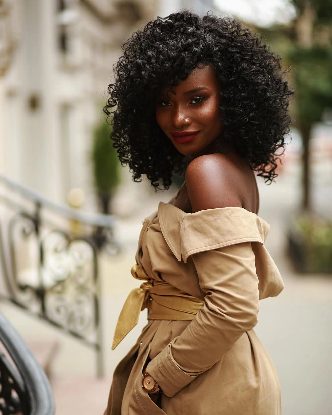 Shoulder-length black ringlets with side-swept rounded volume