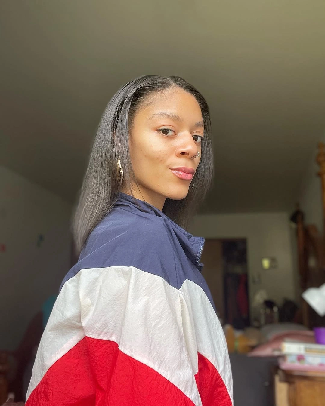 Straight deep brown-black hair with near-center part and smooth lengths
