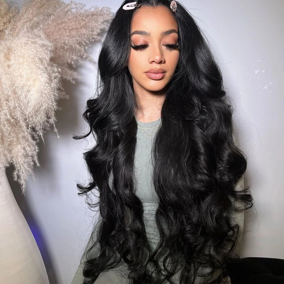 Extremely long glossy black hair with center part and loose waves