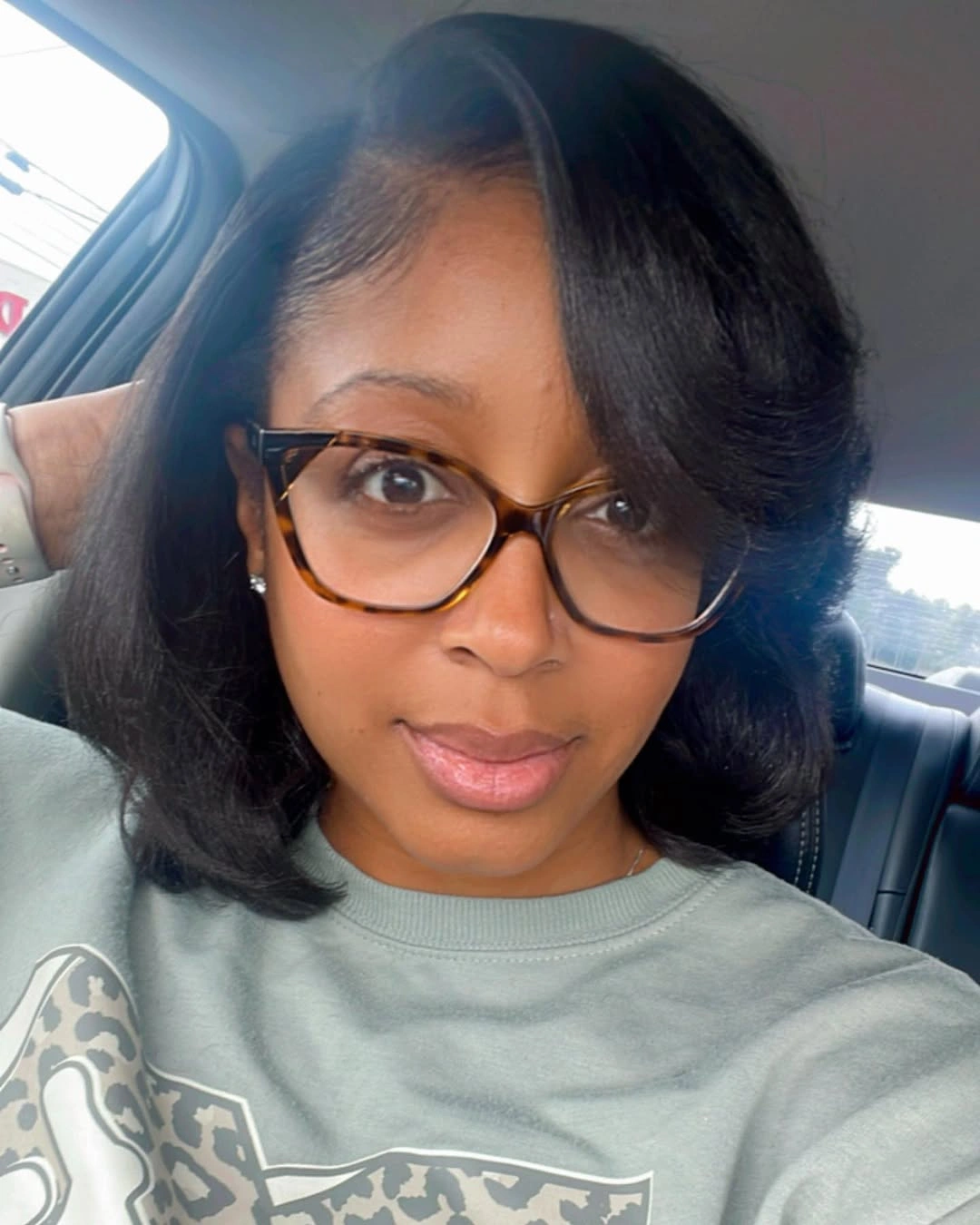 Shoulder-length near-black hair with side sweep and curved ends