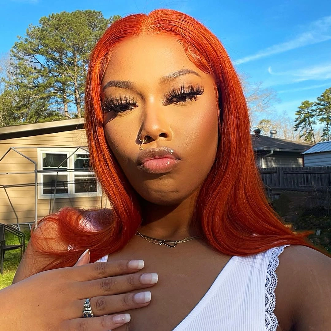 Long straight orange-red hair with center part and curved ends