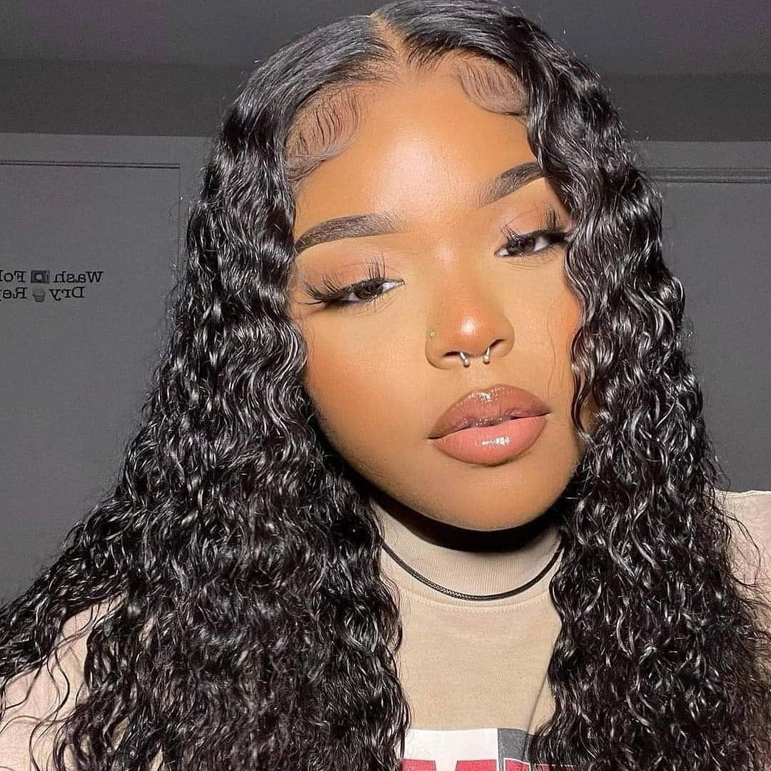 Long glossy black hair with center part and defined waves