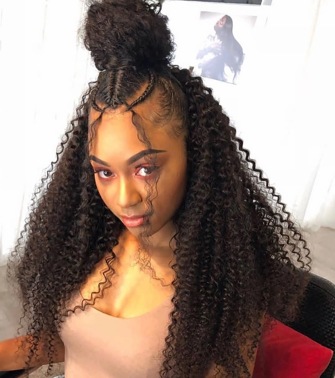 Long dark curls with braided rows and high gathered bun