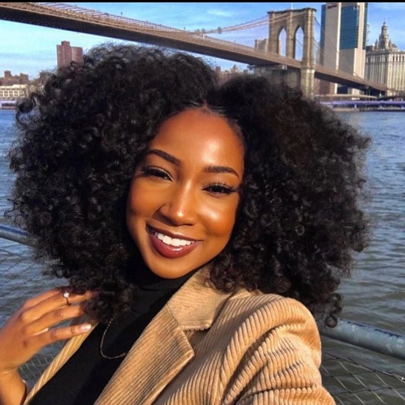 Shoulder-length black curls with center part and rounded volume