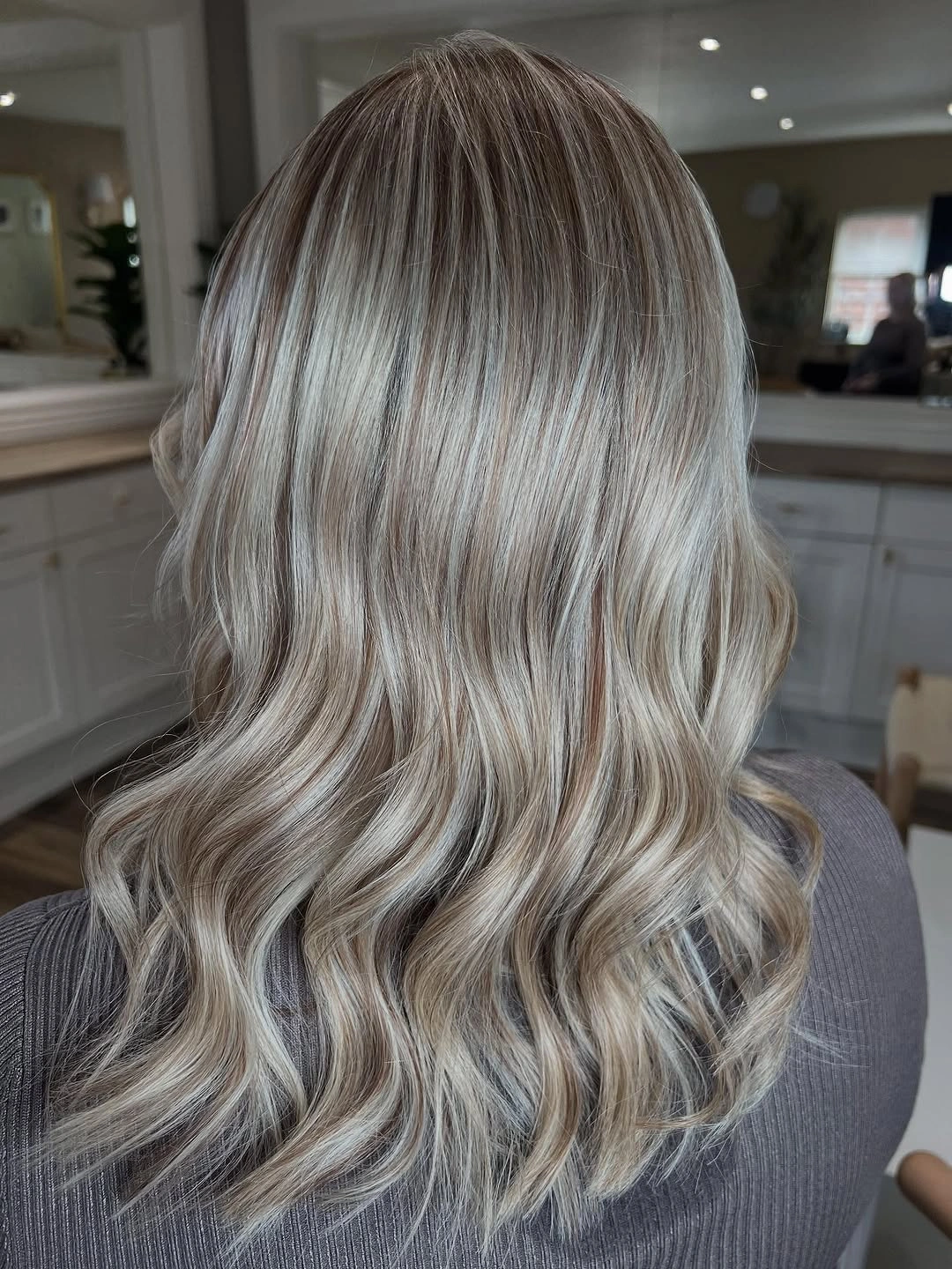 Long ash beige blonde waves with darker root shadow