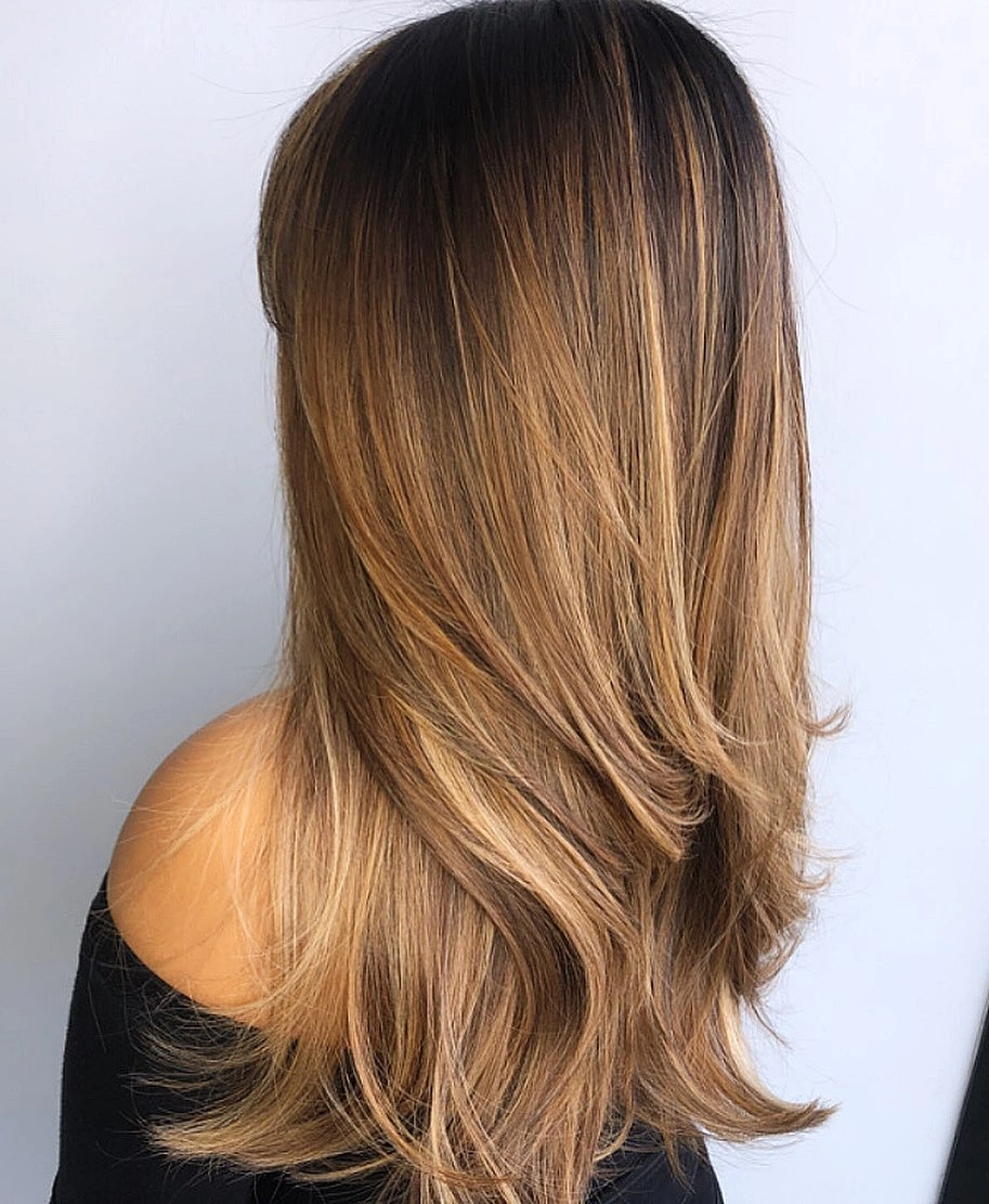 Long straight layered brunette hair with honey caramel ends