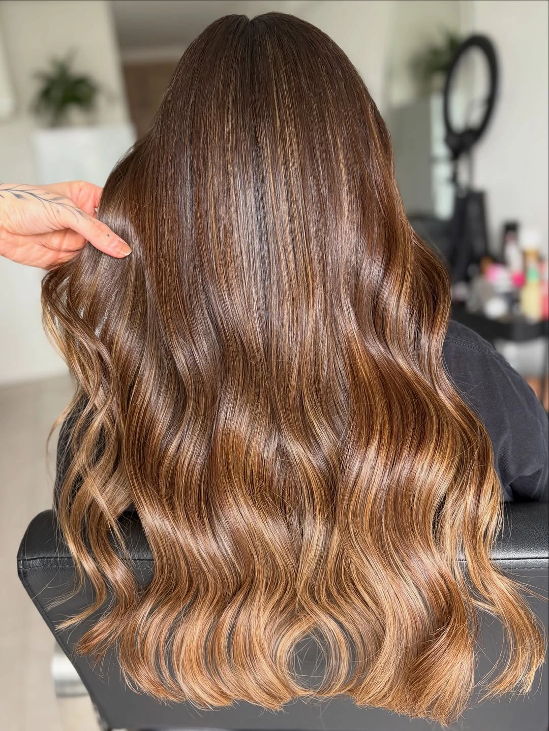 Glossy chestnut brown waves with copper honey highlights