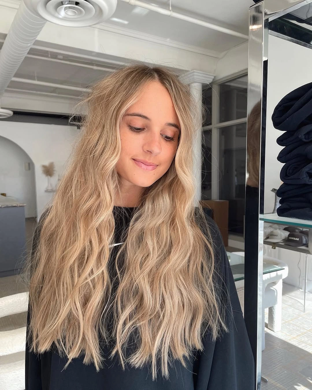 Very long blonde hair with loose waves and softly irregular ends