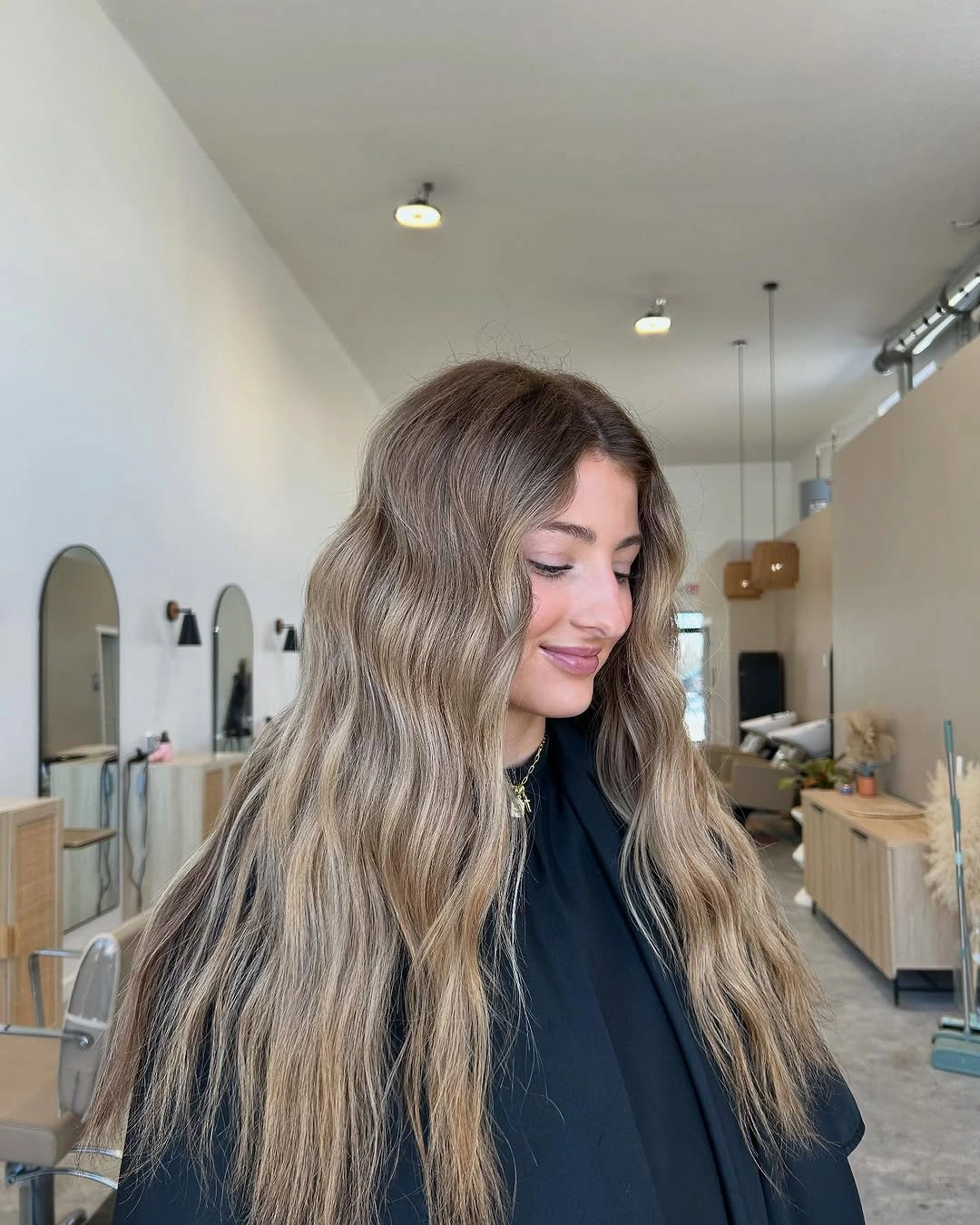 Very long light brown hair with center part and soft bends