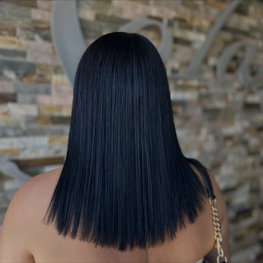 Dark shoulder-length straight hair with dense clean lower perimeter