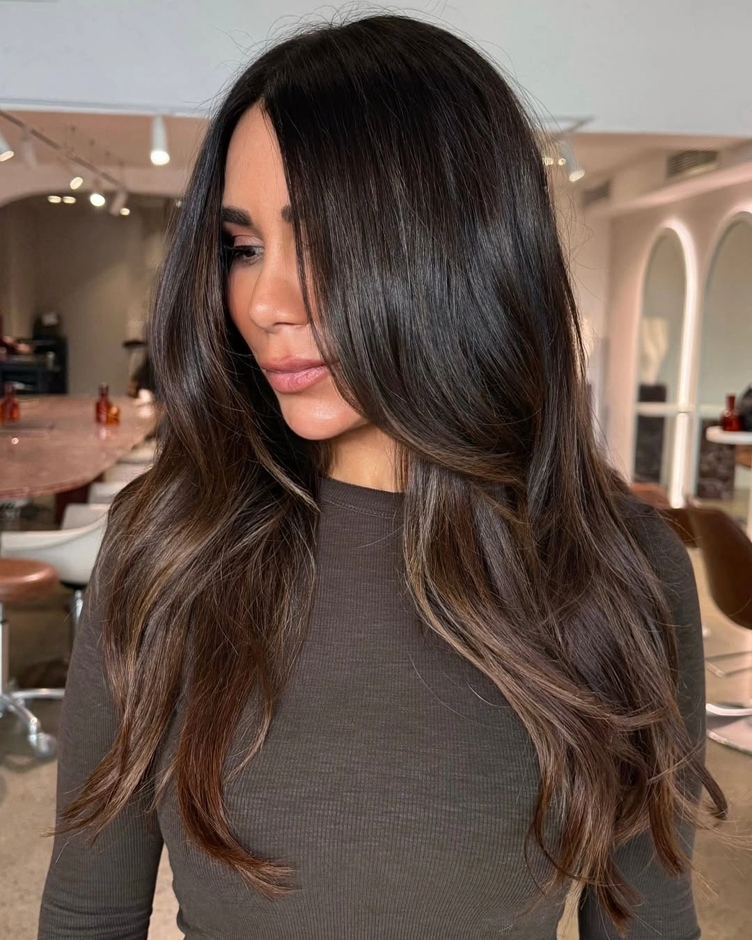 Very long dark brunette hair with center part and face-framing layers