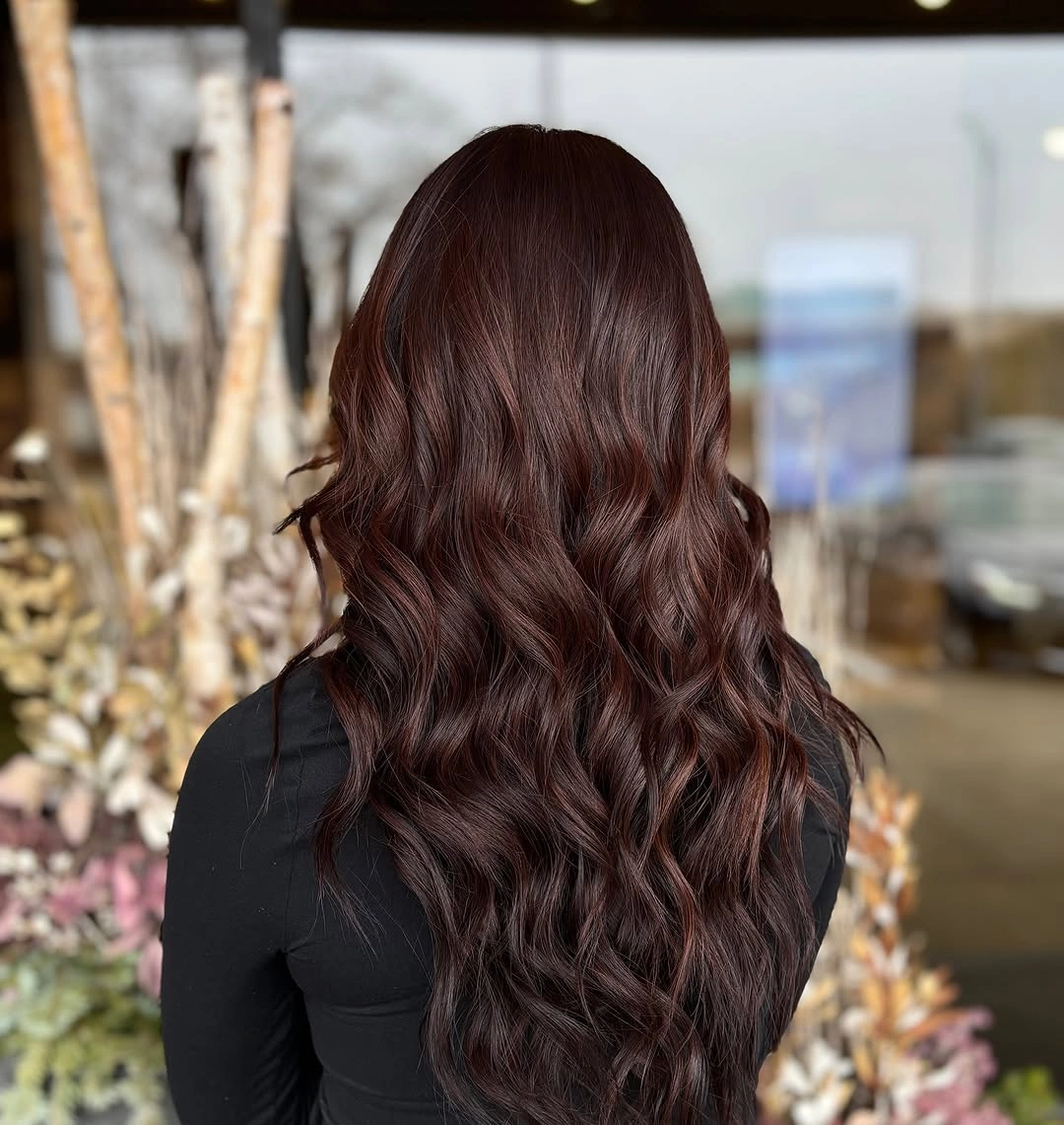 Long deep reddish-brown hair with loose waves and soft ends