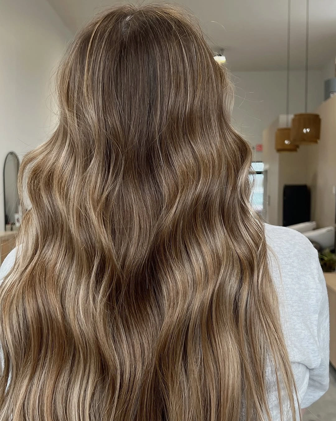 Very long light brown hair with loose waves and tapered ends