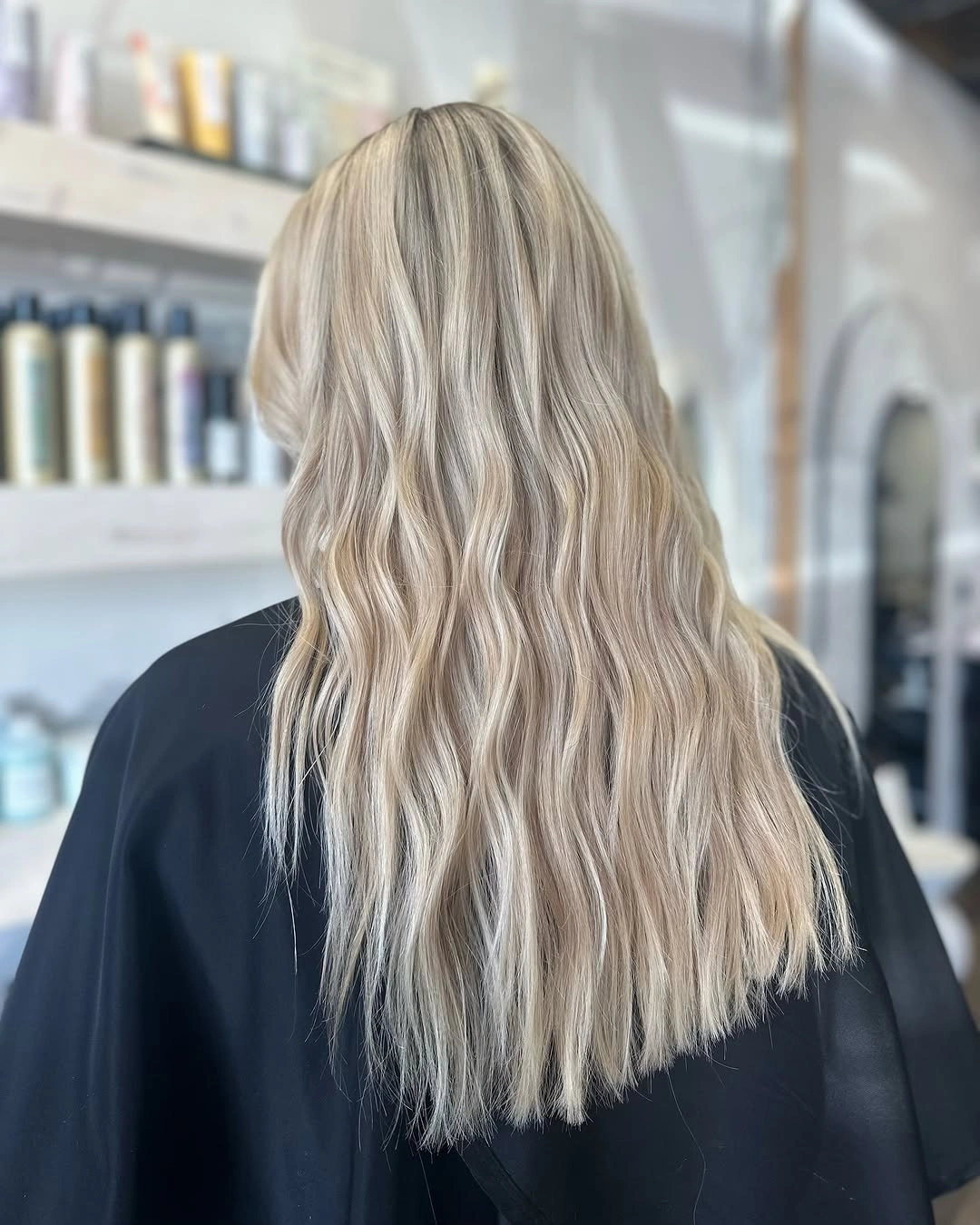 Long pale blonde hair with narrow waves and straight lower edge