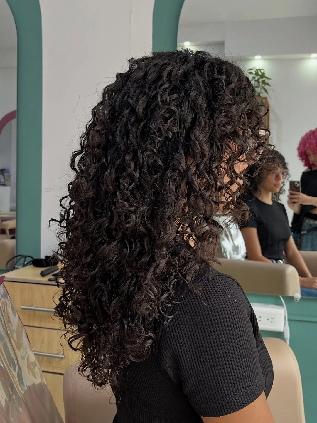 Long dark visible curls with rounded back volume