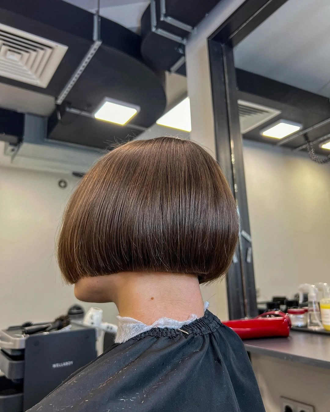 Short warm brown bob with straight back line and rounded crown