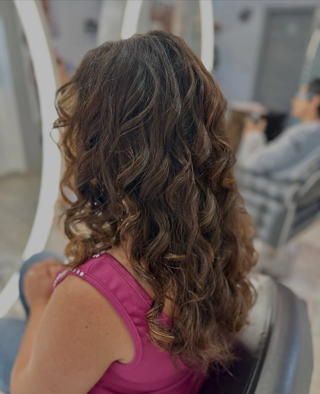 Medium long dark curled hair with lighter textured ends