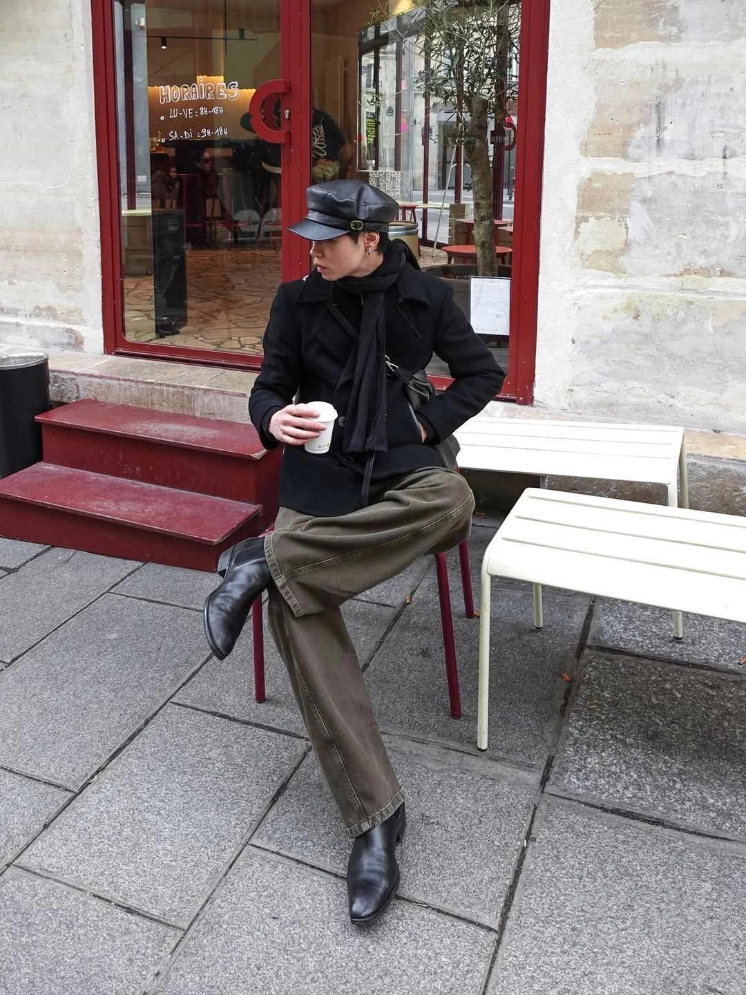 Black cap and jacket with olive trousers and black ankle boots