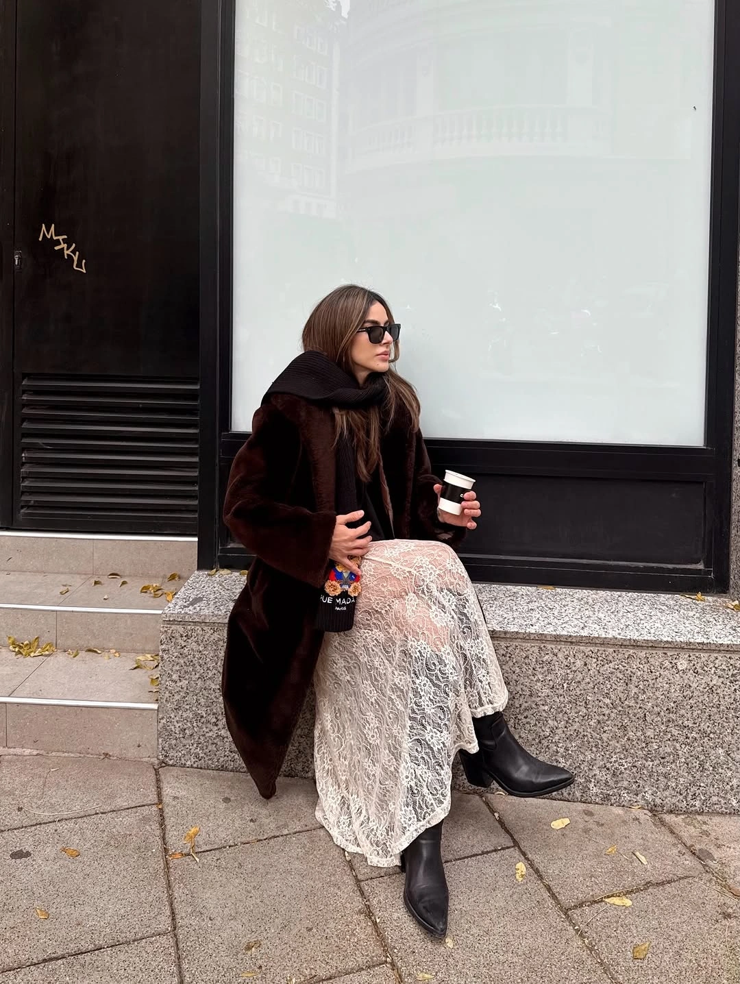 Dark coat and scarf with pale long openwork skirt and black boots