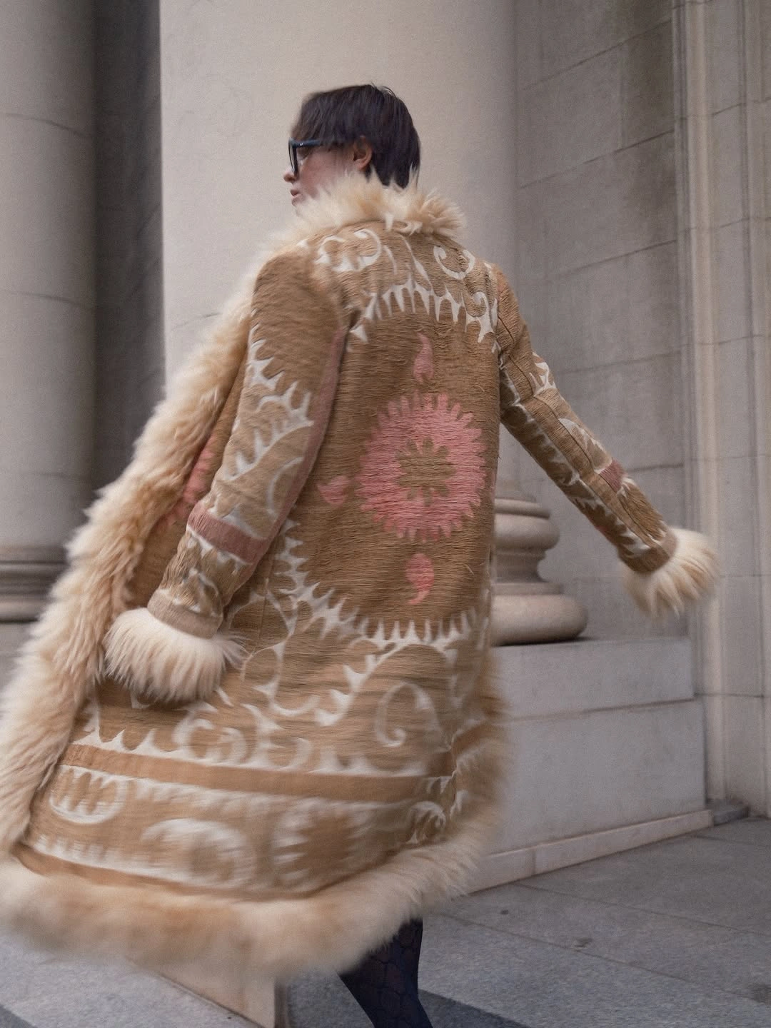 Long tan patterned coat with ivory trim and pink medallion details