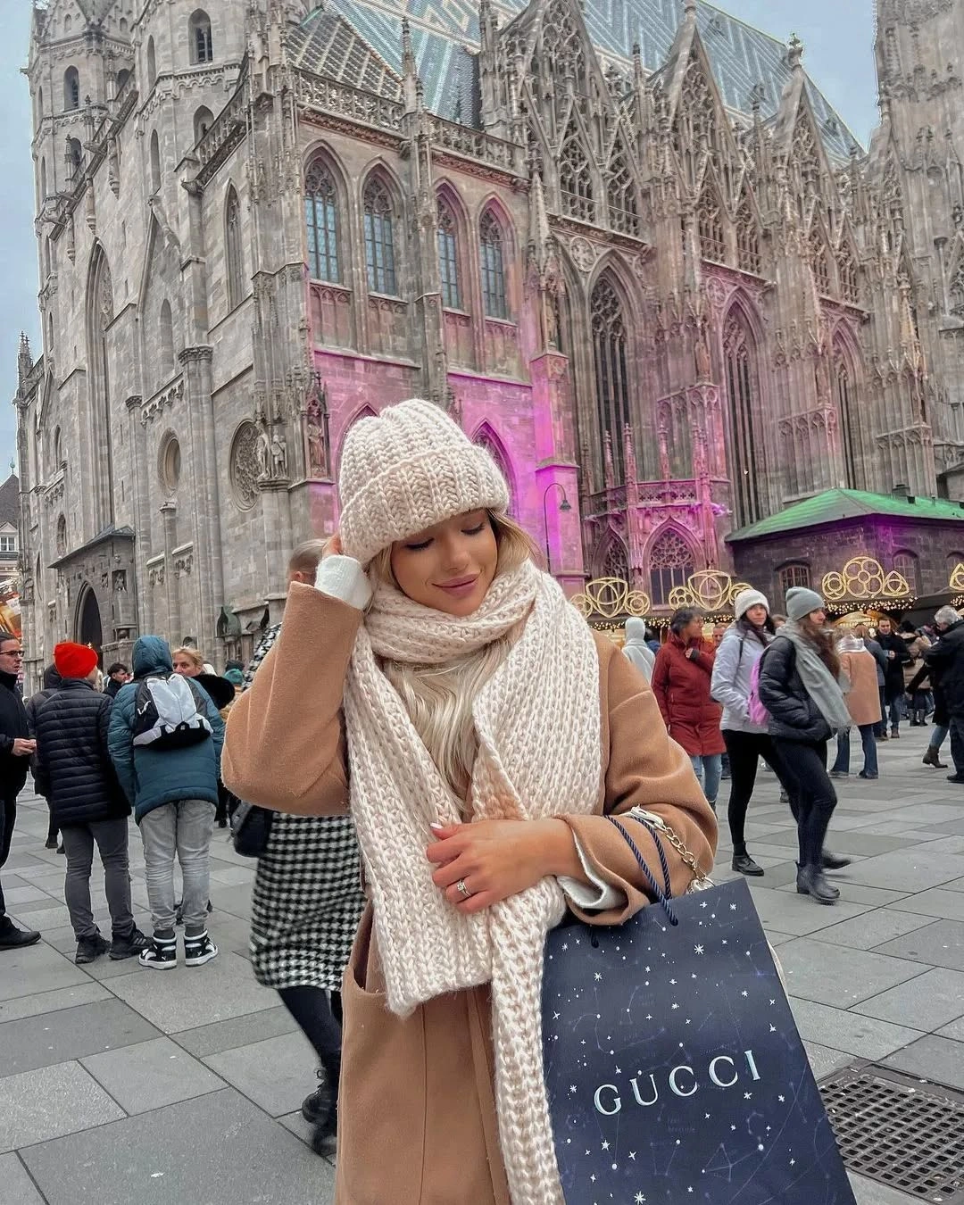 Camel coat with cream knit scarf beanie and checked lower layer