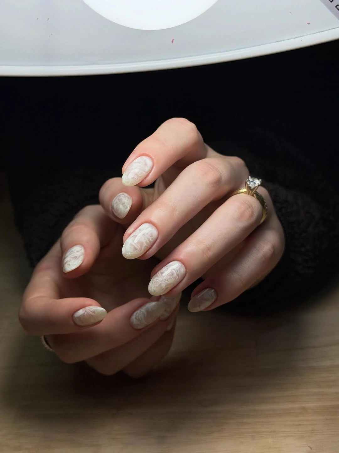 Pale rounded nails with low contrast raised texture