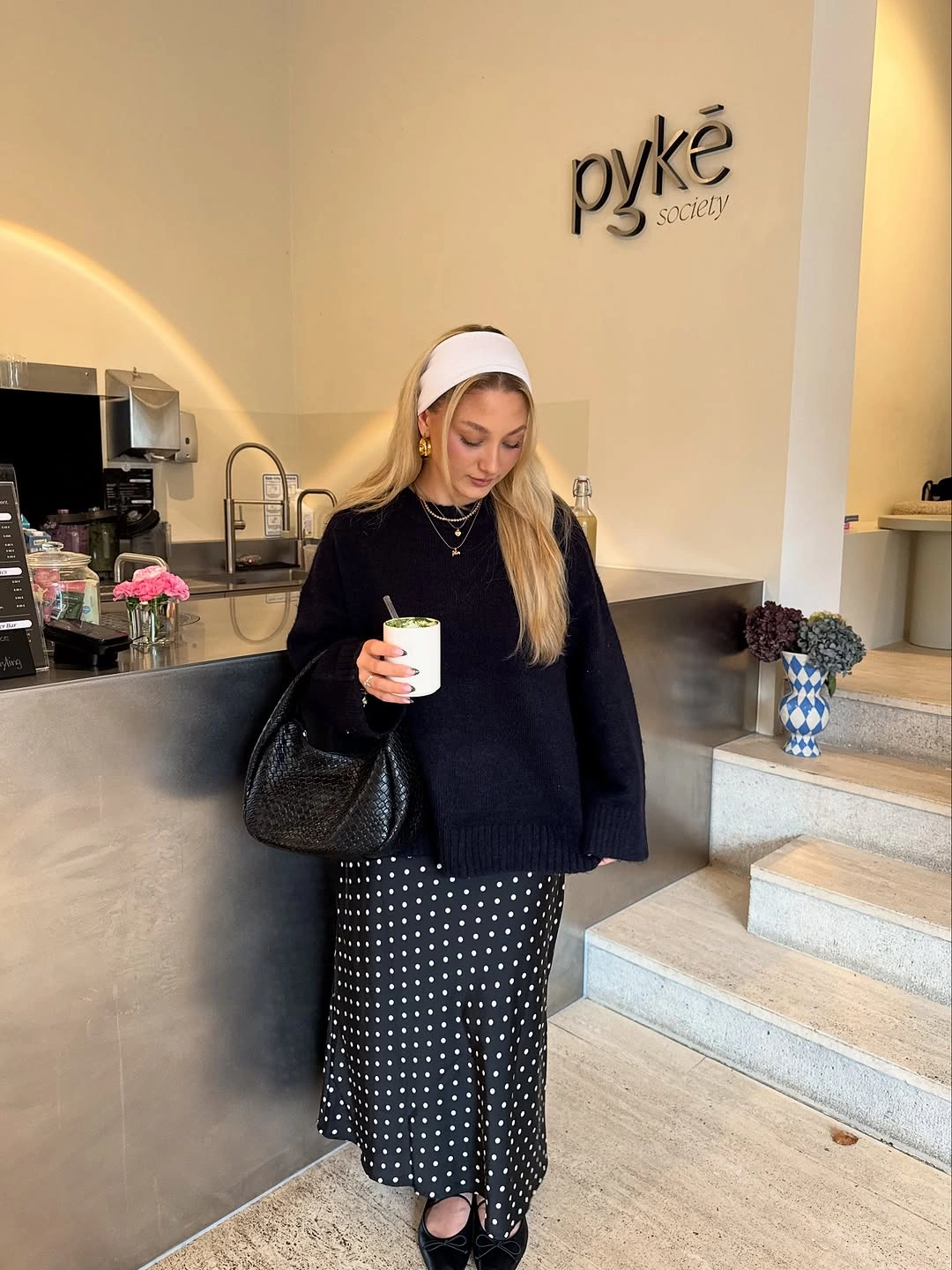 Black knit sweater, polka-dot midi skirt, black bag and shoes
