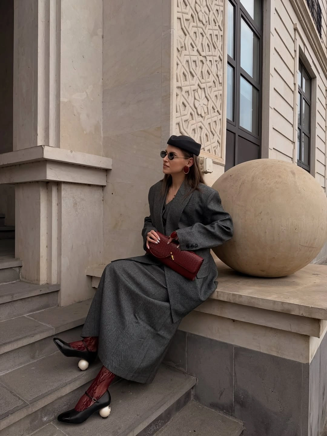 Oversized grey blazer, long grey skirt, burgundy bag and red boots
