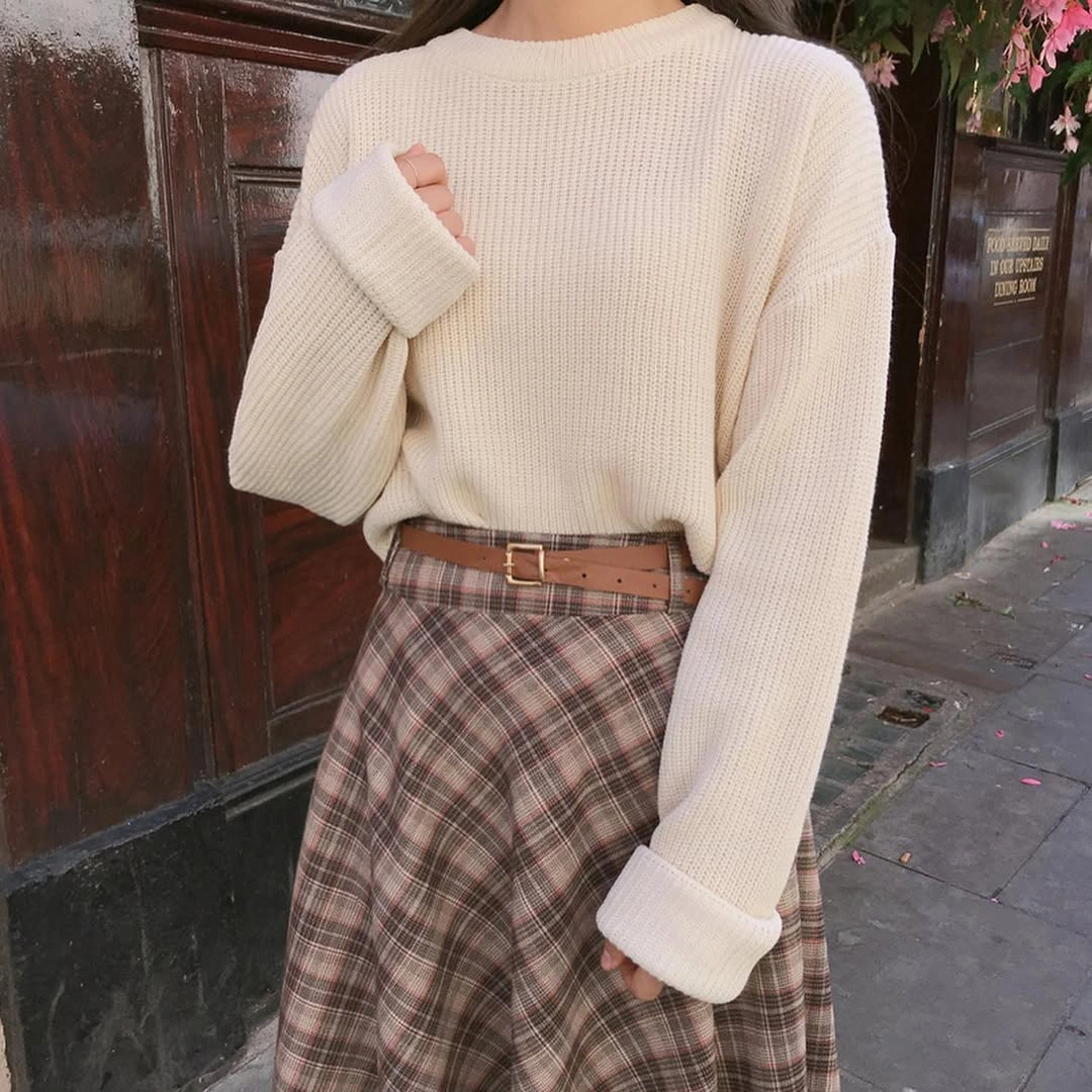 Cream oversized sweater, brown belt and brown plaid skirt