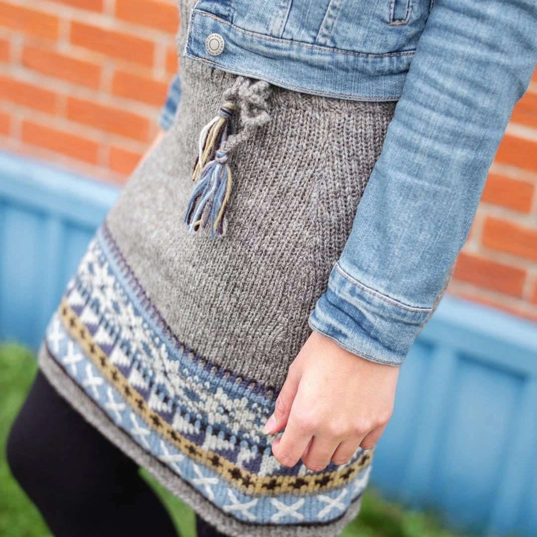 Denim jacket, grey knit lower layer, patterned border and black tights