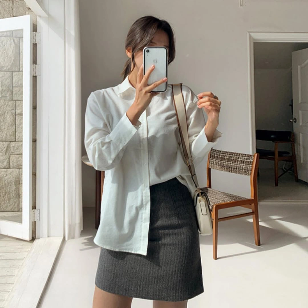 White button-up shirt, charcoal ribbed skirt and brown shoulder bag