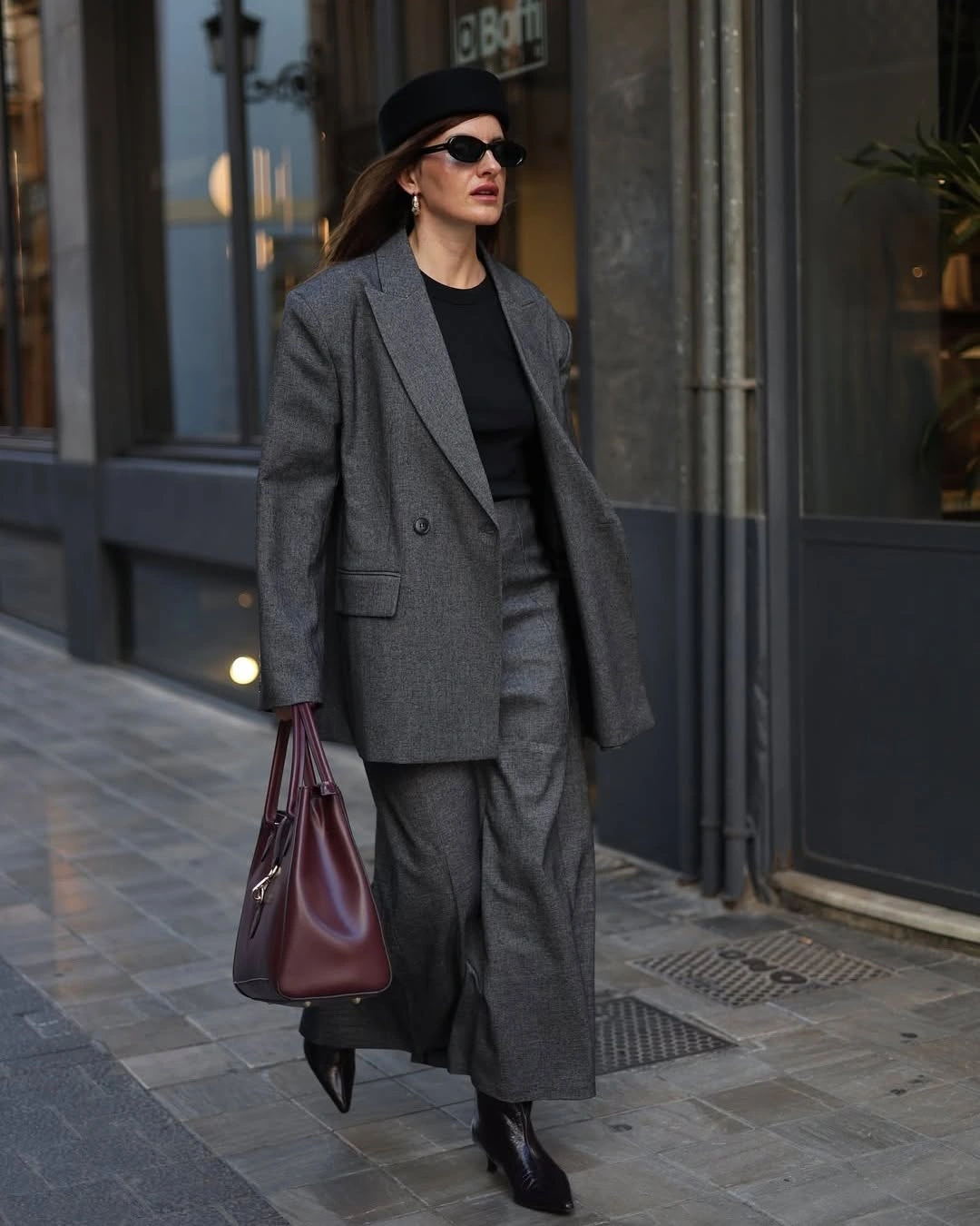 Grey blazer, wide trousers, black top and burgundy tote
