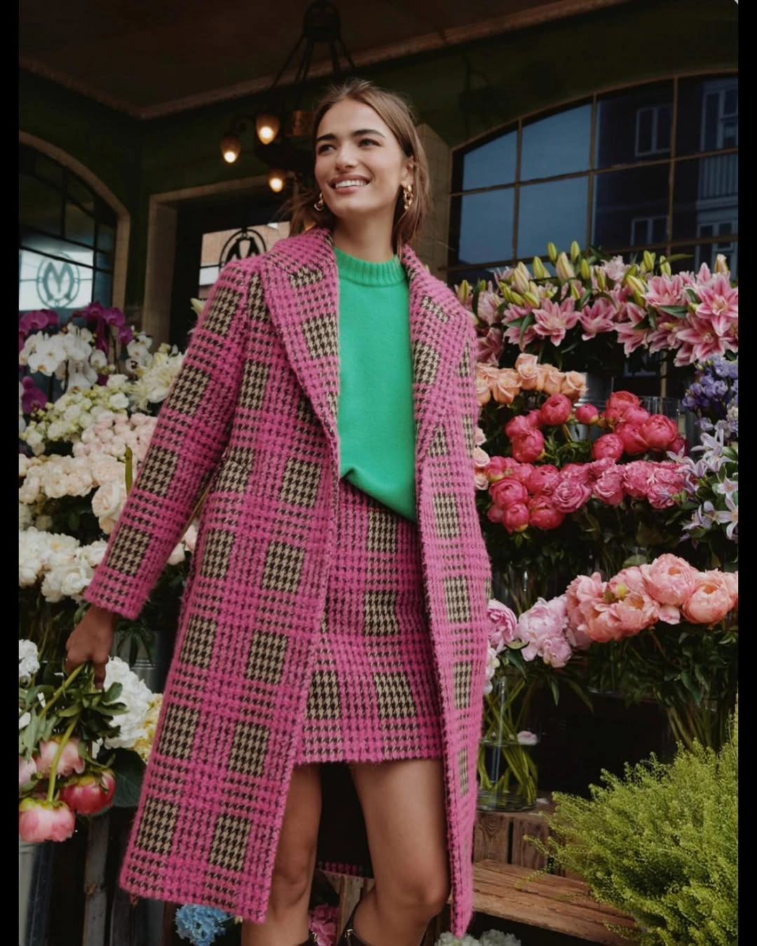 Pink checked coat, matching short skirt and vivid green sweater