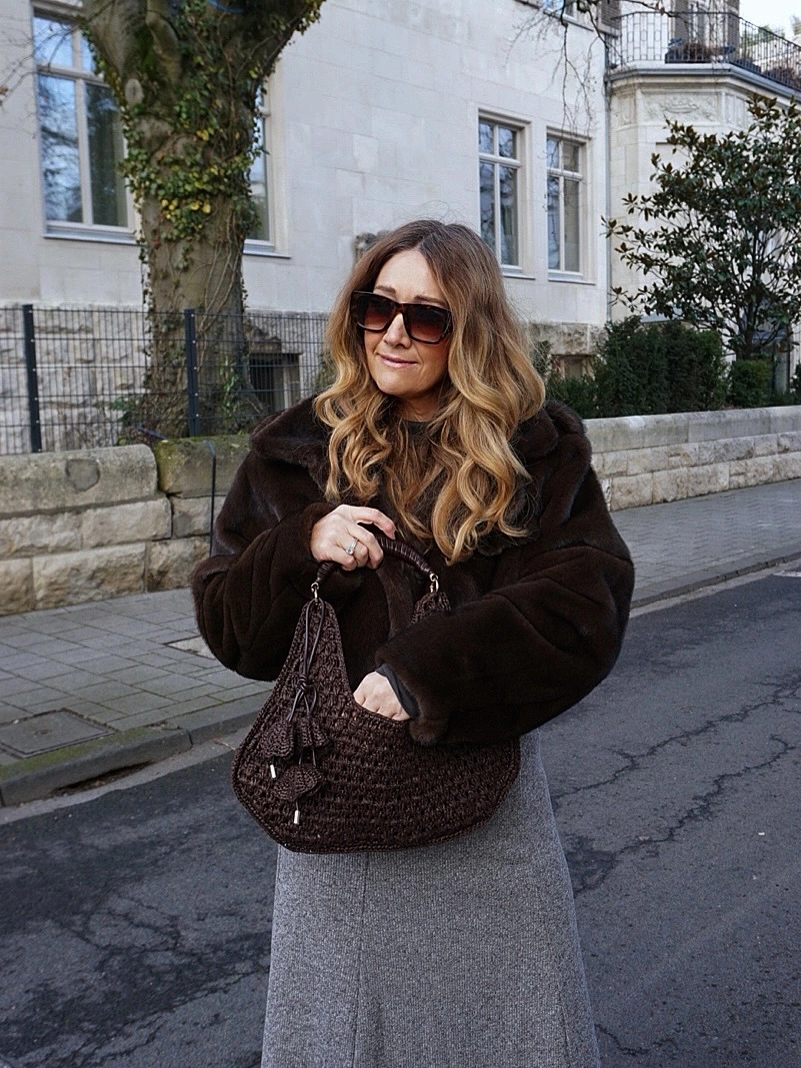 Dark brown coat, grey midi skirt and woven brown handbag