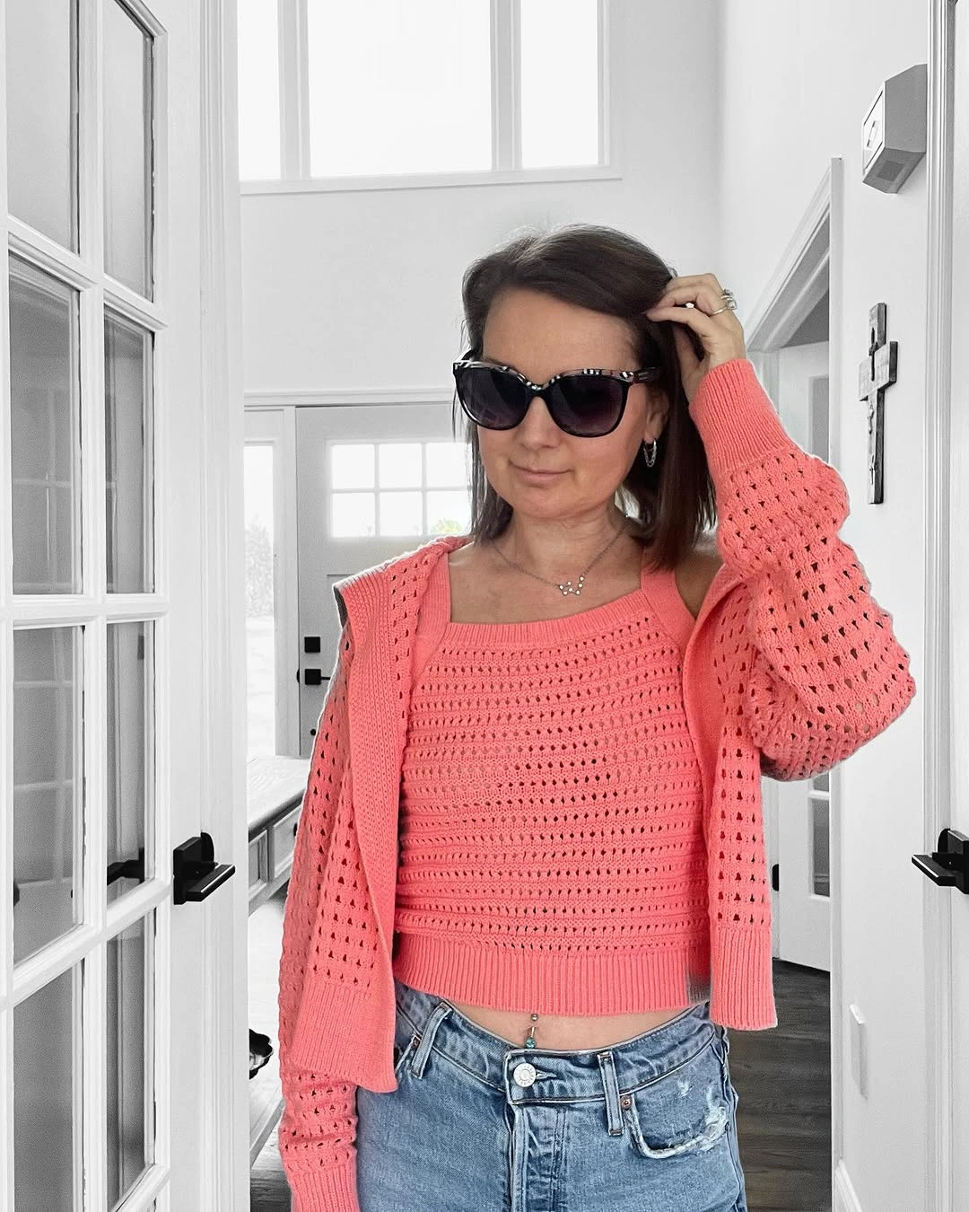 Coral open-knit cardigan and matching top with blue jeans