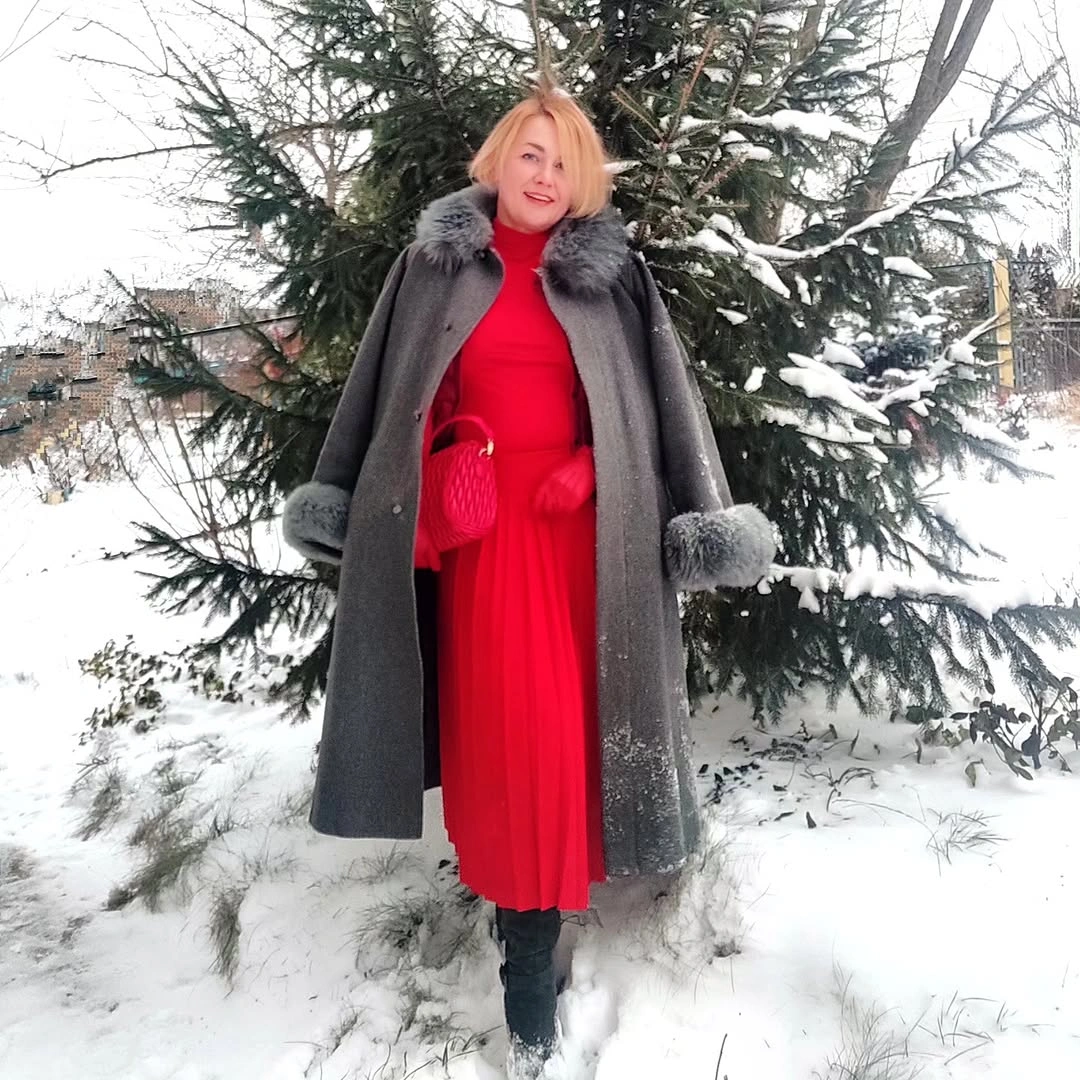 Red column outfit with gray trimmed coat and black boots