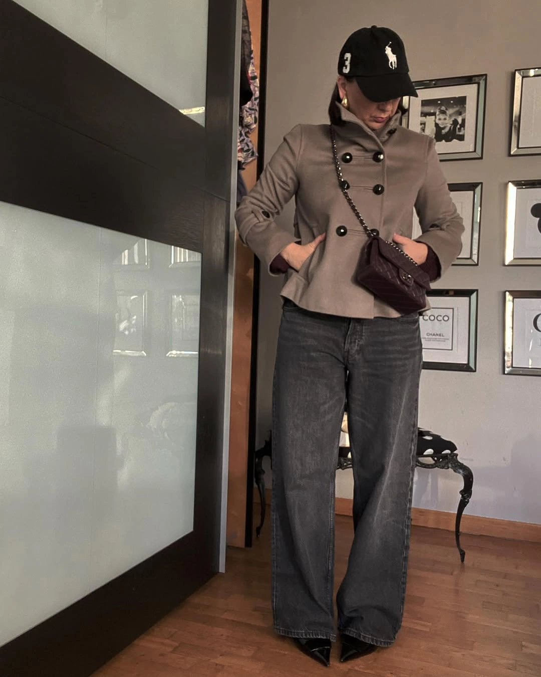 Taupe fitted jacket with gray wide jeans and black cap