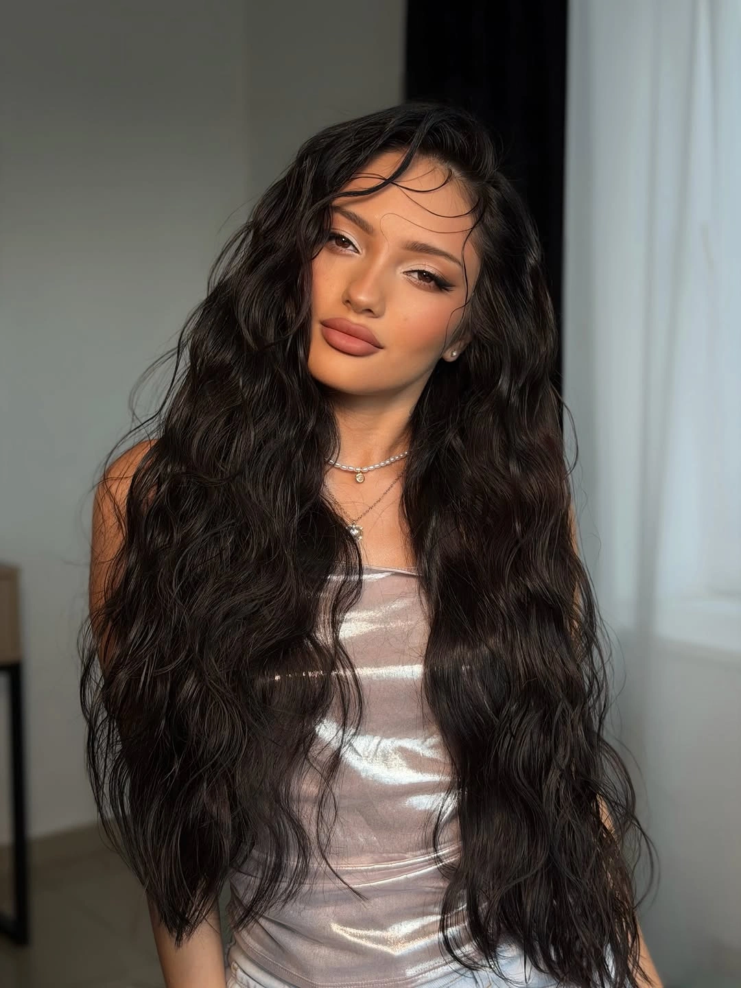 Very long dark hair with loose waves and forehead strands